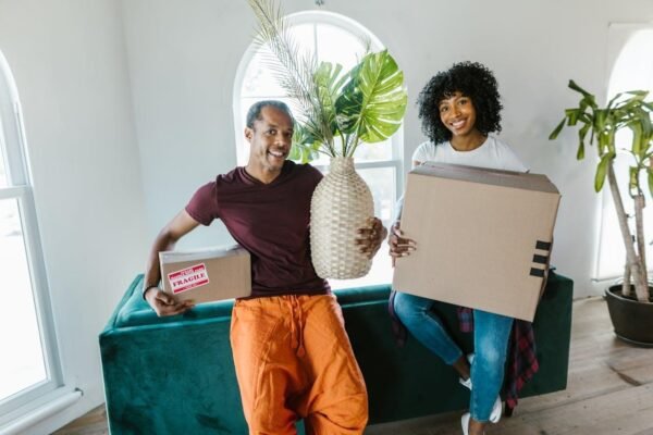 Couple holding moving boxes