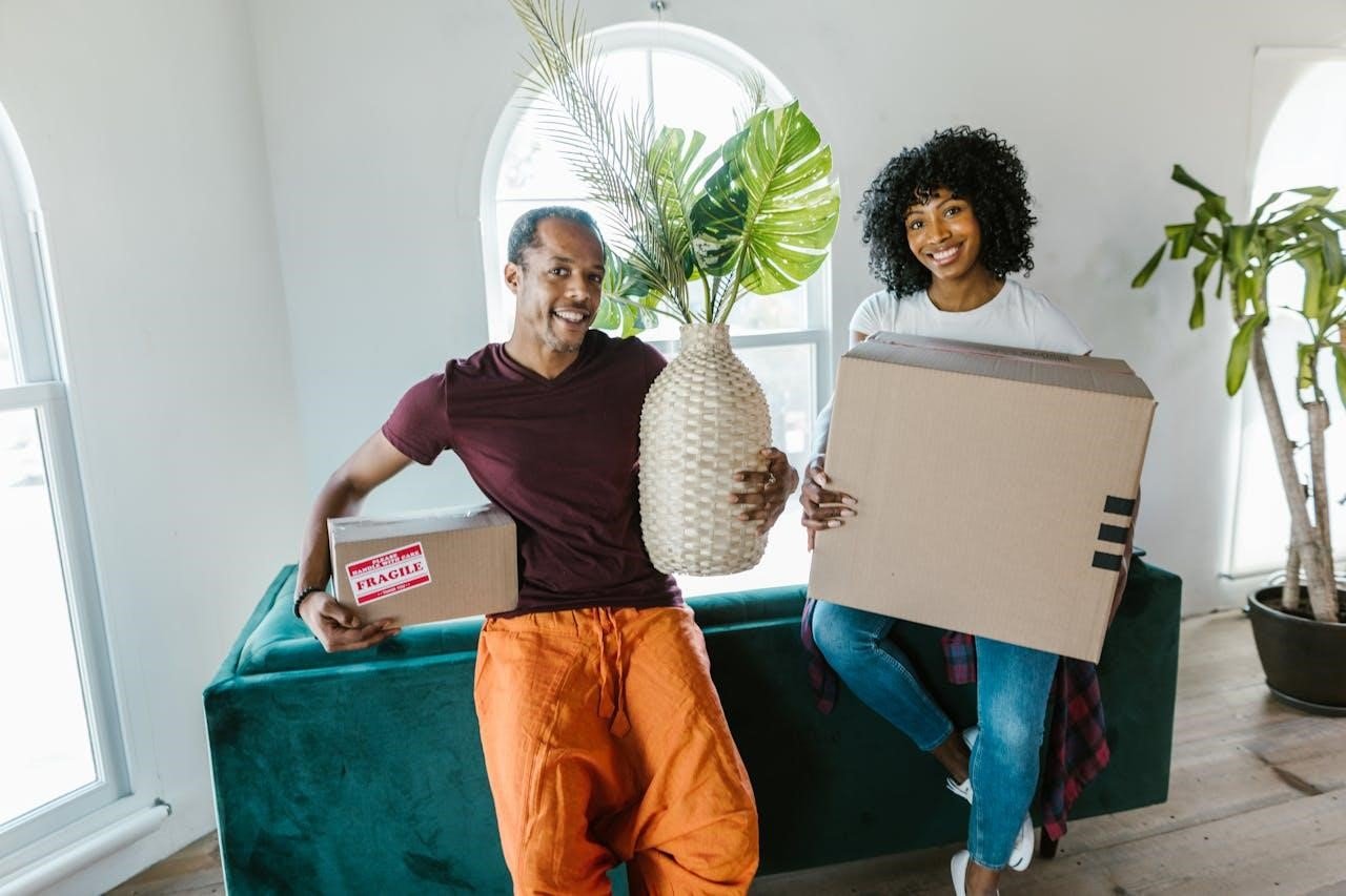 Couple holding moving boxes